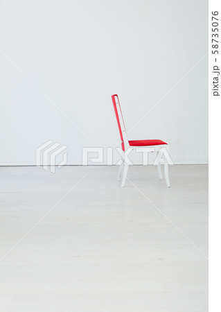 red chair in the interior of an empty white room red chair in the interior of an empty white room 58735076