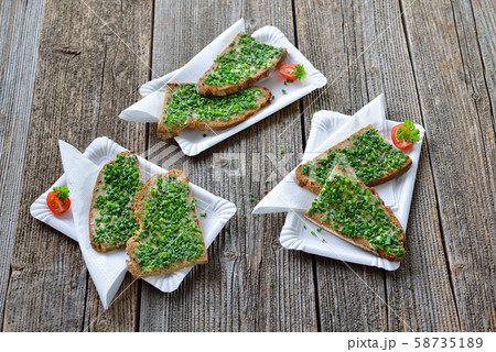 Beer garden food: Slices of fresh farmhouse bread with butter and chopped chives Beer garden food: Slices of fresh farmhouse bread with butter and chopped chives 58735189