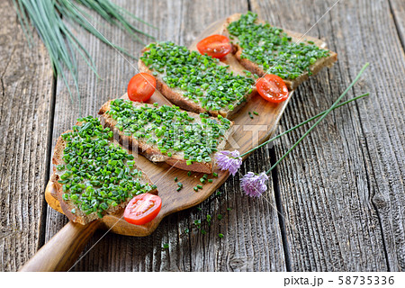 Beer garden food: Slices of fresh farmhouse bread with butter and chopped chives Beer garden food: Slices of fresh farmhouse bread with butter and chopped chives 58735336