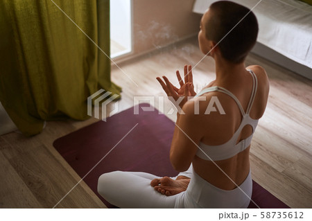 Woman sit in lotus position, above view Woman sit in lotus position, above view 58735612