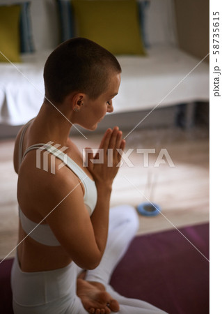Relax exercising in lotus pose with candles at home 58735615