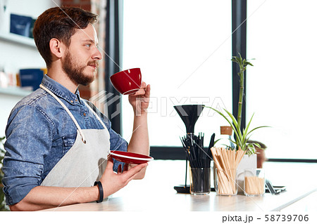 Confident self assured barista at bar counter 58739706