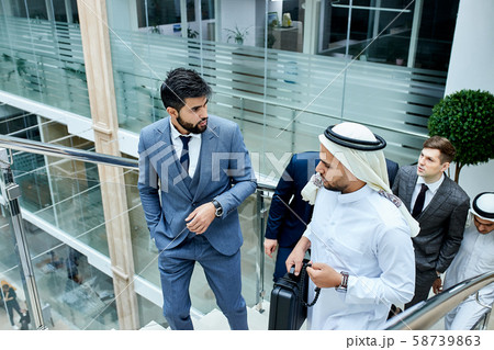 Business people discussing their ideas climbing stairs Business people discussing their ideas climbing stairs 58739863