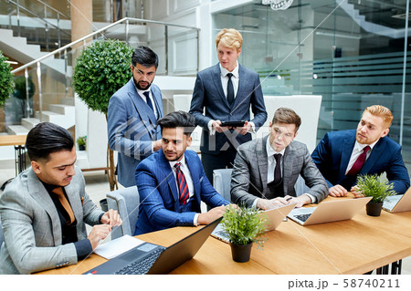 Multi-ethnic corporate business people have discussion at table 58740211