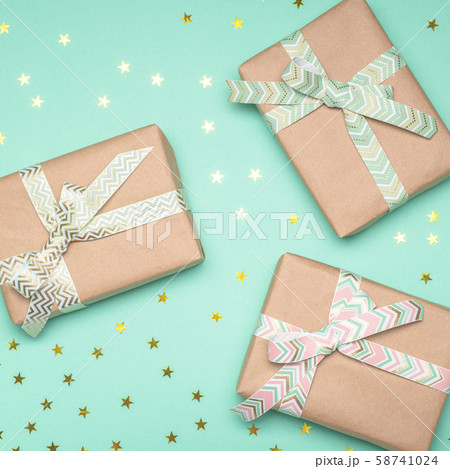 Gift boxes with ribbons on turquoise background. Holiday concept. 58741024