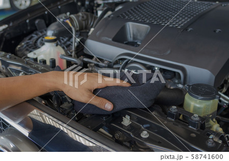 checks and cleans the car's engine. 58741600