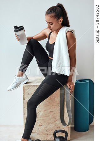 beautiful woman drinking some water from plastic bottle after fitness beautiful woman drinking some water from plastic bottle after fitness 58742502