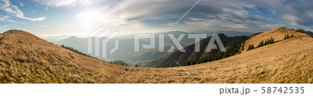 Beautiful sunset and layered mountain silhouettes Beautiful sunset and layered mountain silhouettes 58742535