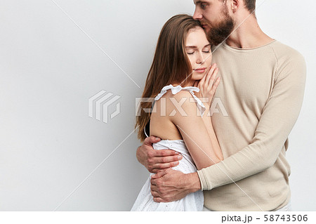 man is hugging his wife, holding in tighet hug man is hugging his wife, holding in tighet hug 58743506