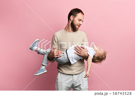 cheerful bearded dad playing a game with his adorable kid 58743528
