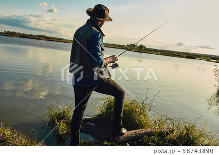 Father and son fishing together on sunny day Father and son fishing together on sunny day 58743890