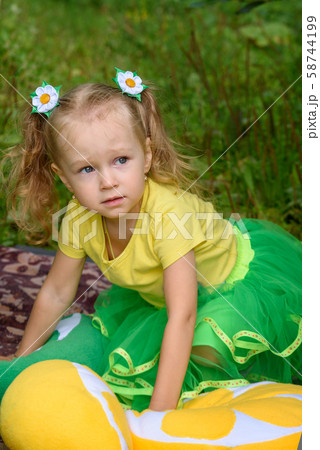 Girl with pillows, lemons, oranges in tent in park Girl with pillows, lemons, oranges in tent in park 58744199