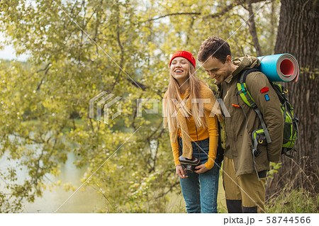 cheerful positive backpackers having fun with camera 58744566