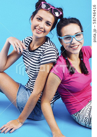 lifestyle people concept: two pretty young school teenage girls having fun happy smiling on blue 58746416