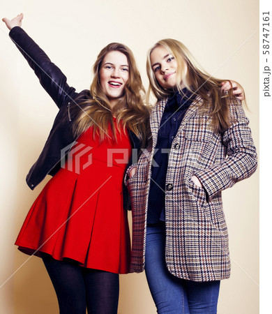 lifestyle and people concept: Fashion portrait of two stylish girls best friends, over white 58747161