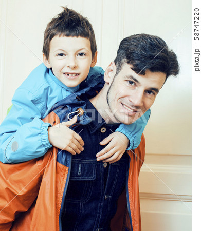 young handsome father with his son fooling around at home, lifestyle people concept close up 58747220