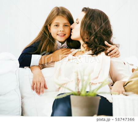 Portrait of smiling young mother and daughter at home, happy family together having fun, lifestyle Portrait of smiling young mother and daughter at home, happy family together having fun, lifestyle 58747366