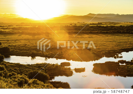 River by field at sunset in Picabo, Idaho, USA River by field at sunset in Picabo, Idaho, USA 58748747