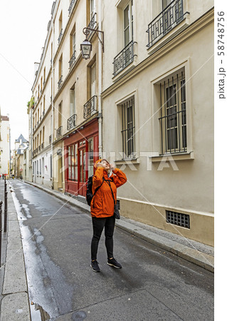 Woman wearing raincoat on street in Paris, France Woman wearing raincoat on street in Paris, France 58748756