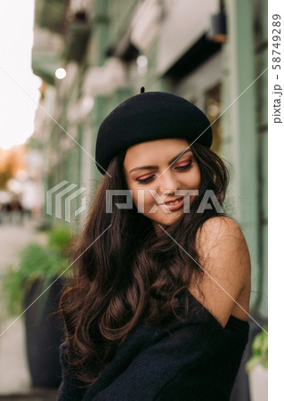 woman dressed in retro style walking around the city. 58749289
