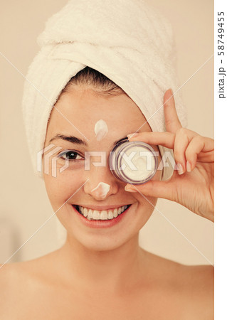 woman holding jar of face cream 58749455