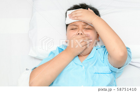 Sick child is coughing and compress on forehead. Sick child is coughing and compress on forehead. 58751410