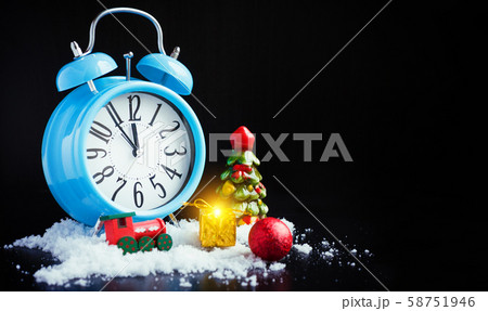Alarm clock and new year decorations on black 58751946