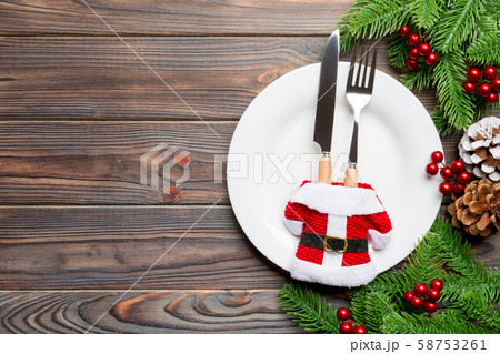 Holiday composition of plate and flatware Holiday composition of plate and flatware 58753261
