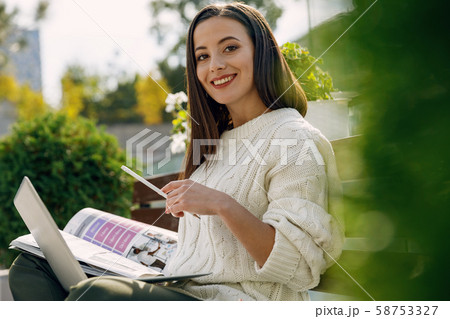 Cheerful female person looking straight at camera Cheerful female person looking straight at camera 58753327