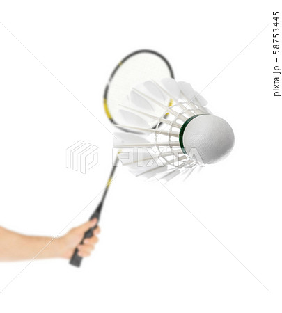 Hand with badminton racket and feather shuttlecock 58753445