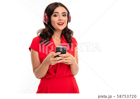 A young woman with red lips, bright makeup, dark wavy long hair, in a red suit, black glasses with 58753720