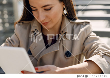 Attentive girl bowing head while reading message 58754640