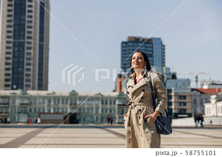 Charming young female standing in the middle of square 58755101