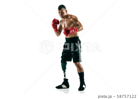 Full length portrait of muscular sportsman with prosthetic leg, copy space. Male boxer in red gloves Full length portrait of muscular sportsman with prosthetic leg, copy space. Male boxer in red gloves 58757122