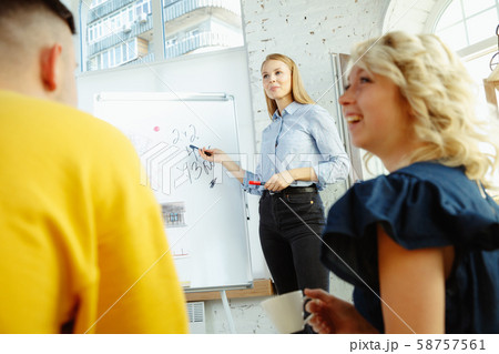 Interior designer working with young couple. Lovely family and professional designer or architector. 58757561