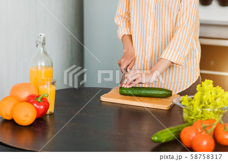 Young woman cooking in the kitchen 58758317