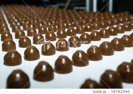 chocolate toppings on the conveyor of a 58762040