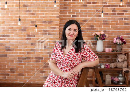 Portrait of a brunette woman in a red and white Portrait of a brunette woman in a red and white 58763762