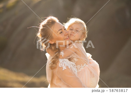 Portrait of a beautiful young mom holds her Portrait of a beautiful young mom holds her 58763817