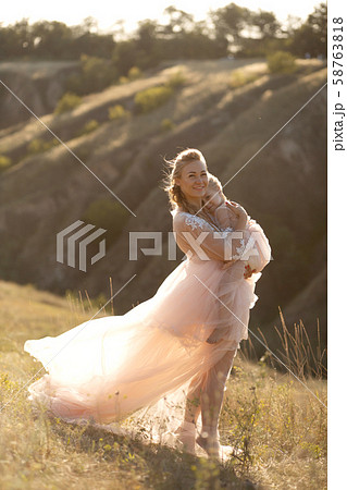 A young family in nature in identical dresses. 58763818