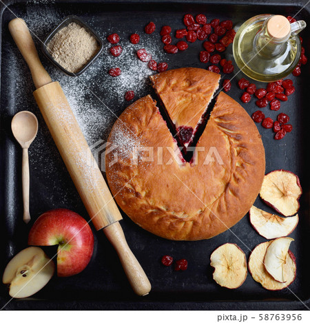 authentic pie on a black background with ingredients 58763956