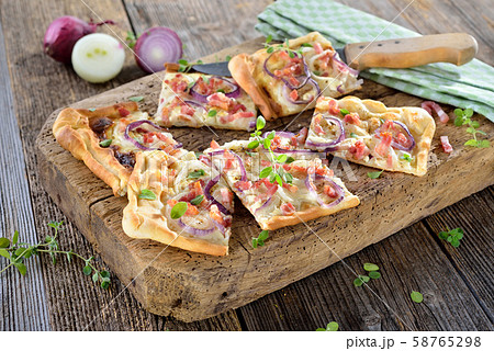 Tarte flambee from Alsace with onions, bacon and sour cream served 58765298
