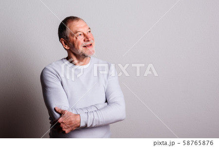 Portrait of a thoughtful senior man with beard and mustache in a studio. Portrait of a thoughtful senior man with beard and mustache in a studio. 58765876