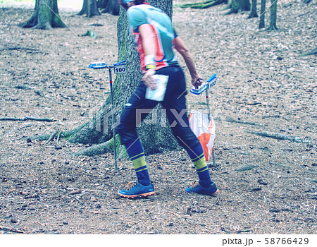 Runners use digital checking point in forest 58766429