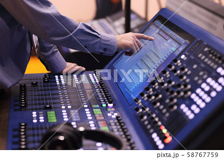 operator working with digital mixing console operator working with digital mixing console 58767759