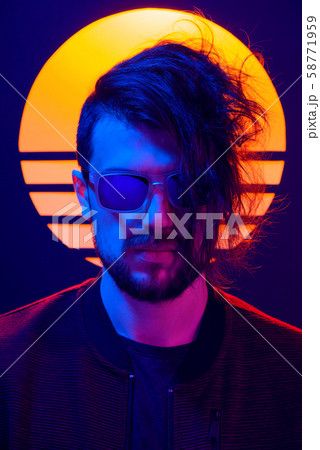 Retro wave synth wave portrait of a young man in sunglasses. 80s sci-fi futuristic fashion poster style violet neon with sun on background. 58771959