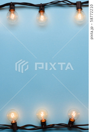 Light bulbs retro garland string lights on blue background 58772210