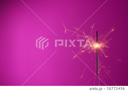 Sparkler on pink background with copy-space Sparkler on pink background with copy-space 58772456