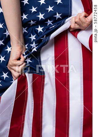 Woman hands pull USA american flag concept 58772458