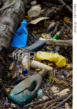 Plastic pollution muddy puddle with bottles waste and styrofoam on ocean beach. 58772492